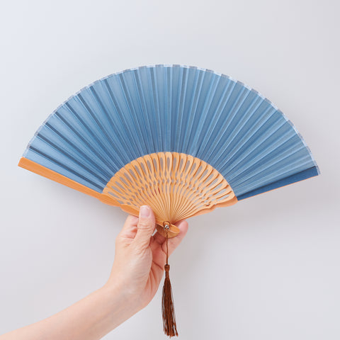 Left-handed folding fan with silk fabric and light brown bamboo ribs, includes cloth case and wooden gift box.