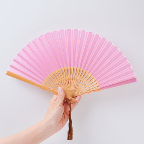 Left-handed folding fan with silk fabric and light brown bamboo ribs, includes cloth case and wooden gift box.