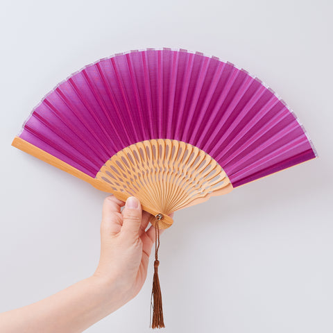 Left-handed folding fan with silk fabric and light brown bamboo ribs, includes cloth case and wooden gift box.