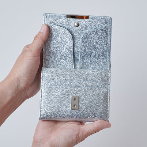 Left-handed wallet in ice blue embossed leather with spacious coin pocket and 12 card slots, handcrafted by Yamato Tokyo.