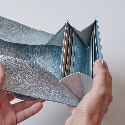 Left-handed wallet in ice blue embossed leather with spacious coin pocket and 12 card slots, handcrafted by Yamato Tokyo.