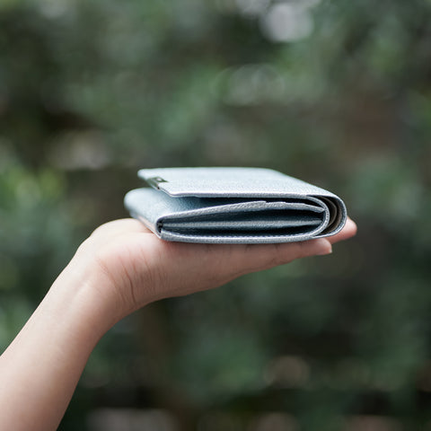 Left-handed wallet in ice blue embossed leather with spacious coin pocket and 12 card slots, handcrafted by Yamato Tokyo.