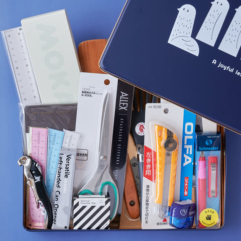 Complete gift set of left-handed tools including kitchenware and stationery, packed in an original designer tin box.