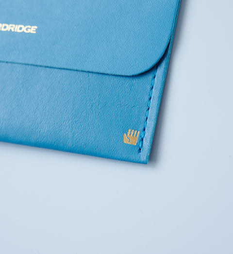 Ultra-thin left-handed leather card holder in cobalt blue, holds about 5 cards, made by dünn in Japan.