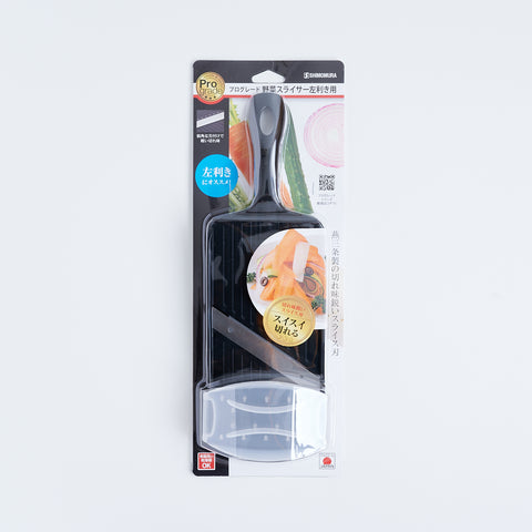 Left-handed vegetable slicer with stainless steel angled blade and safety holder, made in Japan.