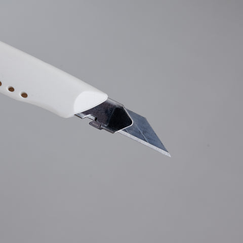 Precision utility knife with 30-degree blade, ergonomic grip, suitable for both left- and right-handed users, designed in Japan.