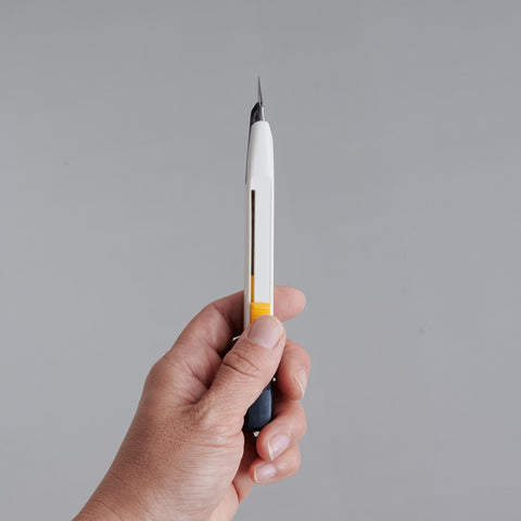 Precision utility knife with 30-degree blade, ergonomic grip, suitable for both left- and right-handed users, designed in Japan.