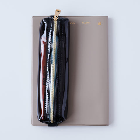 Book strap pencil case with adjustable band, clear PVC, holds 3–4 pens, Japan-made notebook accessory.
