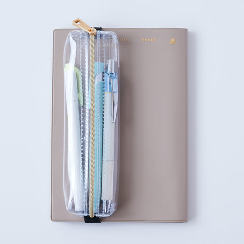Book strap pencil case with adjustable band, clear PVC, holds 3–4 pens, Japan-made notebook accessory.