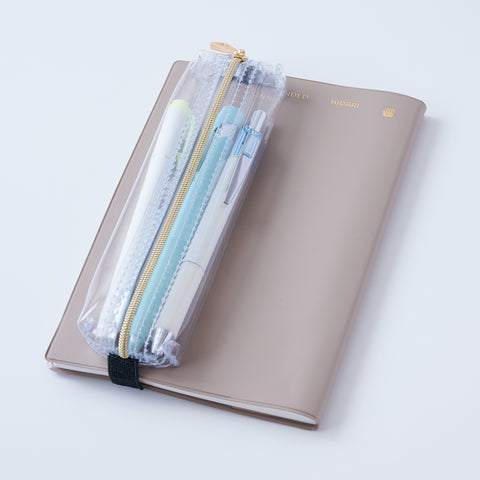 Book strap pencil case with adjustable band, clear PVC, holds 3–4 pens, Japan-made notebook accessory.