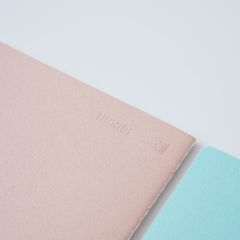 Set of 3 unlined HIDARI notebooks in assorted cover colors, designed for left-handed planners.