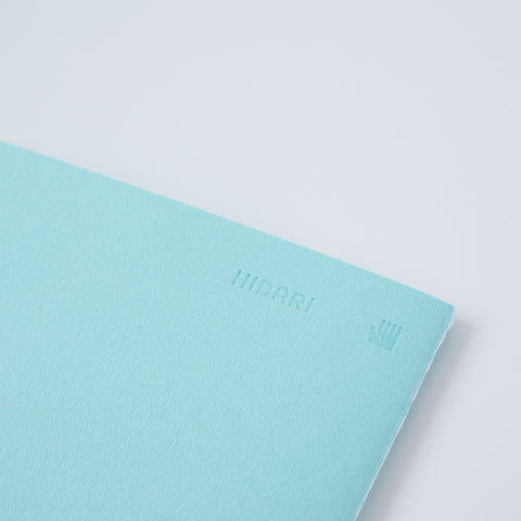 Set of 3 unlined HIDARI notebooks in assorted cover colors, designed for left-handed planners.