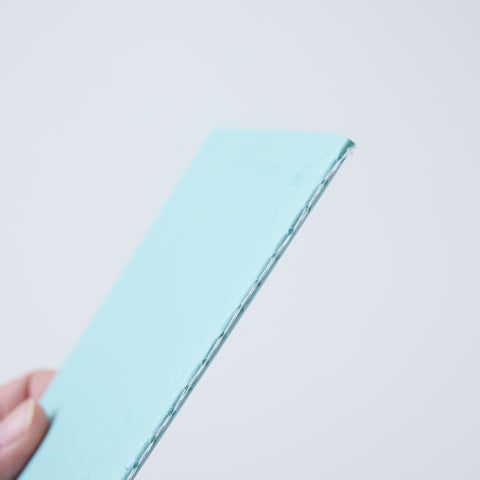 Set of 3 unlined HIDARI notebooks in assorted cover colors, designed for left-handed planners.