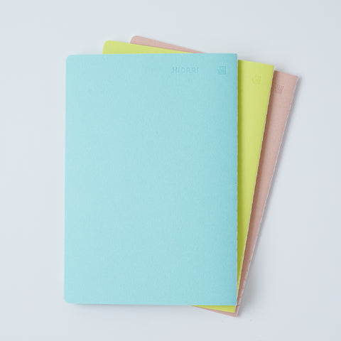 Set of 3 unlined HIDARI notebooks in assorted cover colors, designed for left-handed planners.