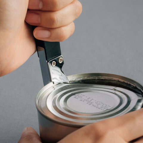 Versatile left-handed can opener with matte black finish, 3-in-1 functionality for cans, bottles, and hole punching, ergonomic design for left-handed users, made in Japan by HIDARI.
