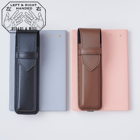 Recycled leather book strap pencil case with adjustable elastic band, shown attached to a notebook.