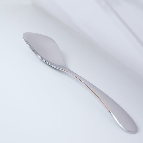 Left-handed stainless steel spoon for curry and rice, polished finish, photographed on white background.