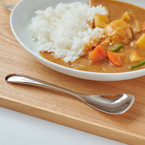 Left-handed stainless steel spoon for curry and rice, polished finish, photographed on black background.