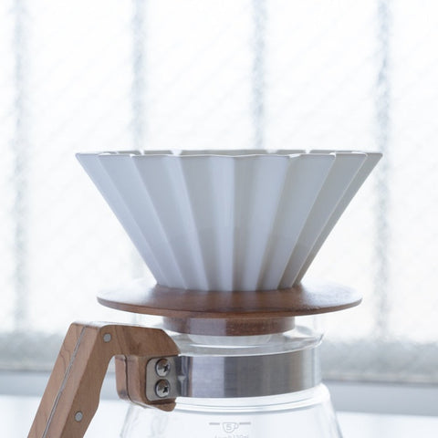 ORIGAMI porcelain coffee dripper with wooden holder, inspired by Japanese origami design.
