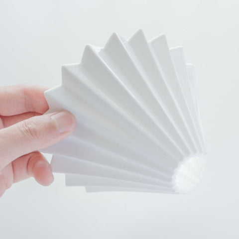 ORIGAMI porcelain coffee dripper with wooden holder, inspired by Japanese origami design.