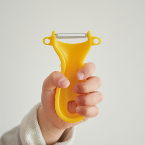 SUNCRAFT kids vegetable peeler with narrow stainless steel blade and ambidextrous handle, designed for ages 4–10, made in Japan.