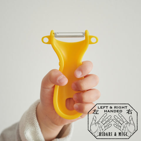 SUNCRAFT kids vegetable peeler with narrow stainless steel blade and ambidextrous handle, designed for ages 4–10, made in Japan.