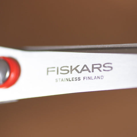FISKARS left-handed all-purpose scissors with red handles and stainless steel blades, large 210mm size, made in Finland.
