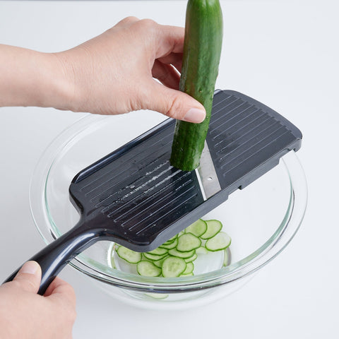 Slicing a cucumber with the left hand using the Left-Handed Vegetable Slicer.