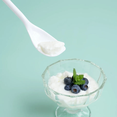 The left-handed long-handled dessert spoon being used to effortlessly scoop yogurt