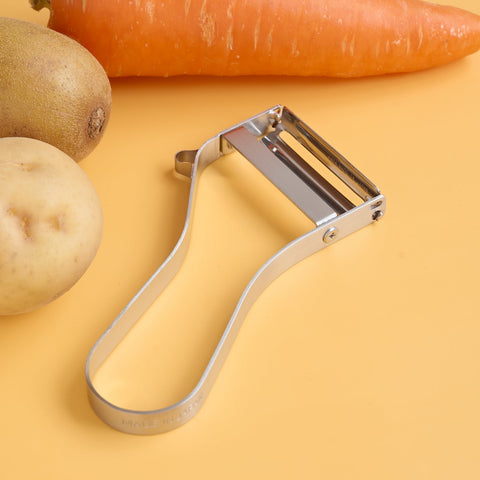 The Ever Peeler Mini for left-handers is shown with vegetables in the background for easy peeling