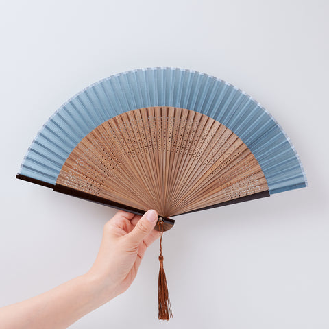 folding fan (with dark brown ribs), left-handed