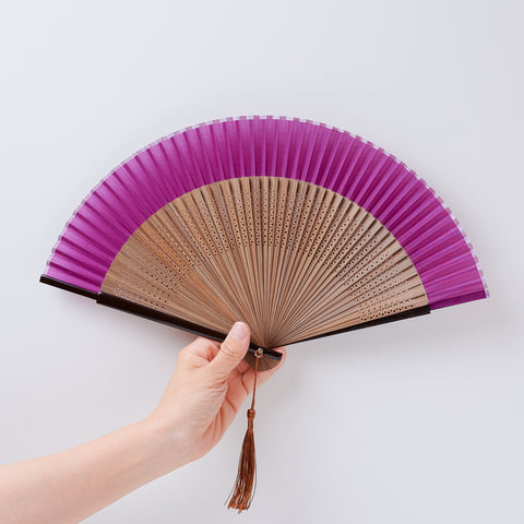 folding fan (with dark brown ribs), left-handed