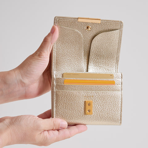 Left-handed Champagne Gold wallet with wide-opening coin pocket, 12 card slots, and reversed bill compartment.