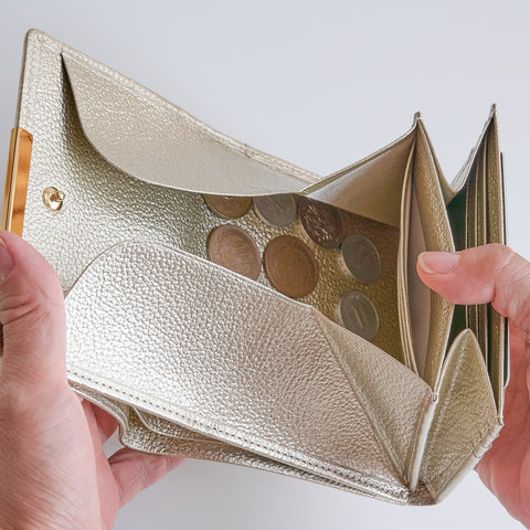 Left-handed Champagne Gold wallet with wide-opening coin pocket, 12 card slots, and reversed bill compartment.