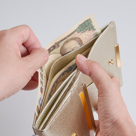 Champagne Gold bifold wallet designed for natural bill access with the left hand.