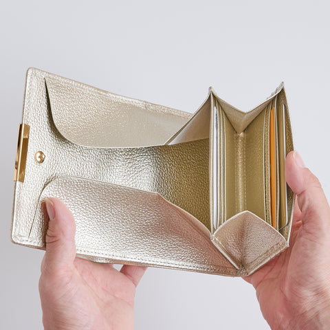 Left-handed Champagne Gold wallet with wide-opening coin pocket, 12 card slots, and reversed bill compartment.