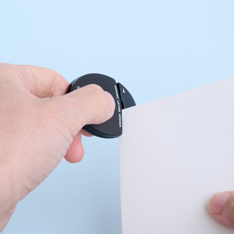 Ambidextrous letter opener with ceramic blade, 5 colors, compact and safe design.