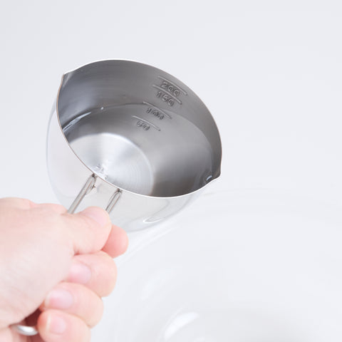 Stainless steel measuring cup 200ml ambidextrous design with dual spouts and long handle, made in Tsubame, Japan.