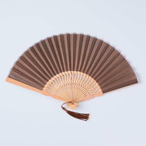 folding fan (with light brown ribs), left-handed