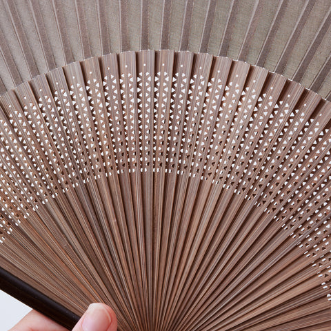 folding fan (with dark brown ribs), left-handed